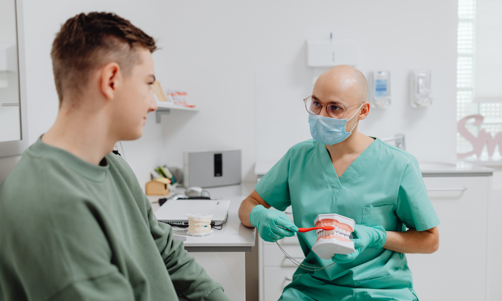 dentist explaining dental crowns vs veneers treatment options Greenacres FL