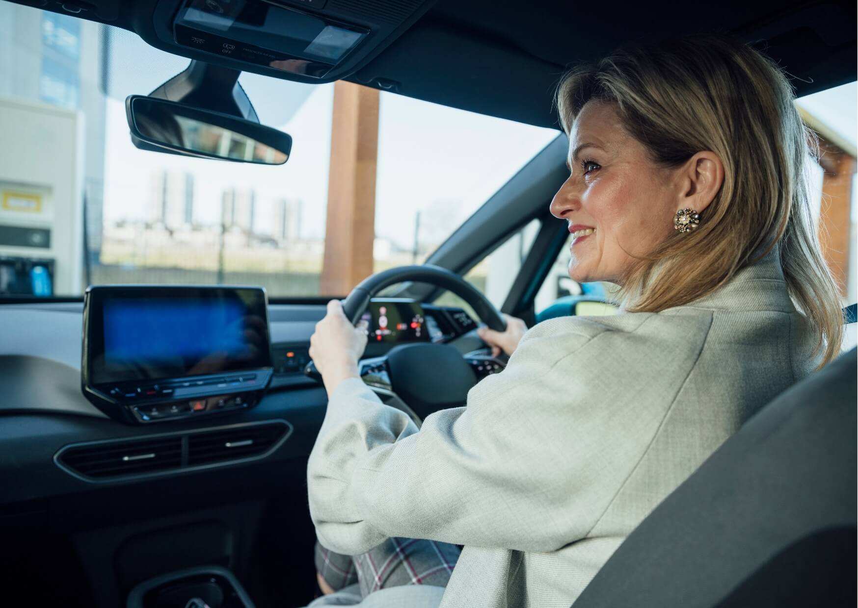 Woman driving after a root canal, illustrating when patients can safely resume driving following dental treatment.