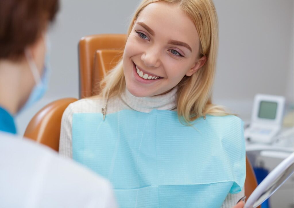 Smiling patient discussing toothache relief options with a dentist during a dental consultation