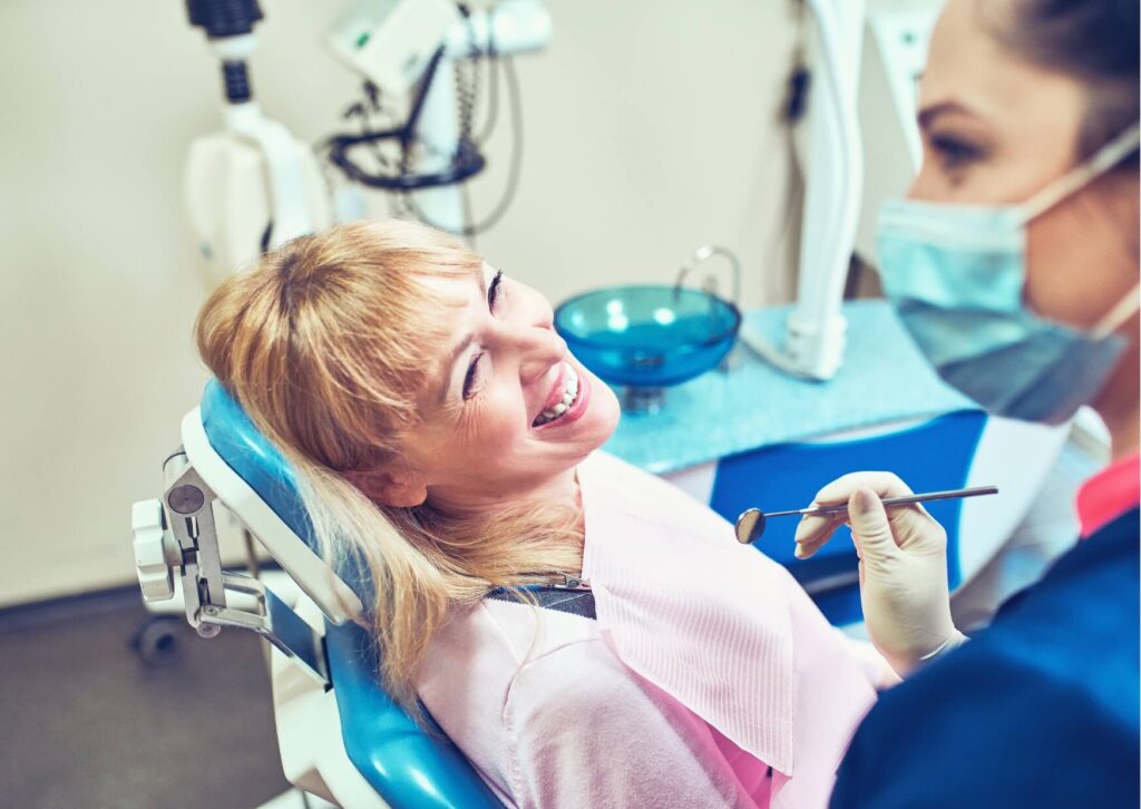 Patient discussing treatment options with a dentist to determine if it is too late to get dental implants.
