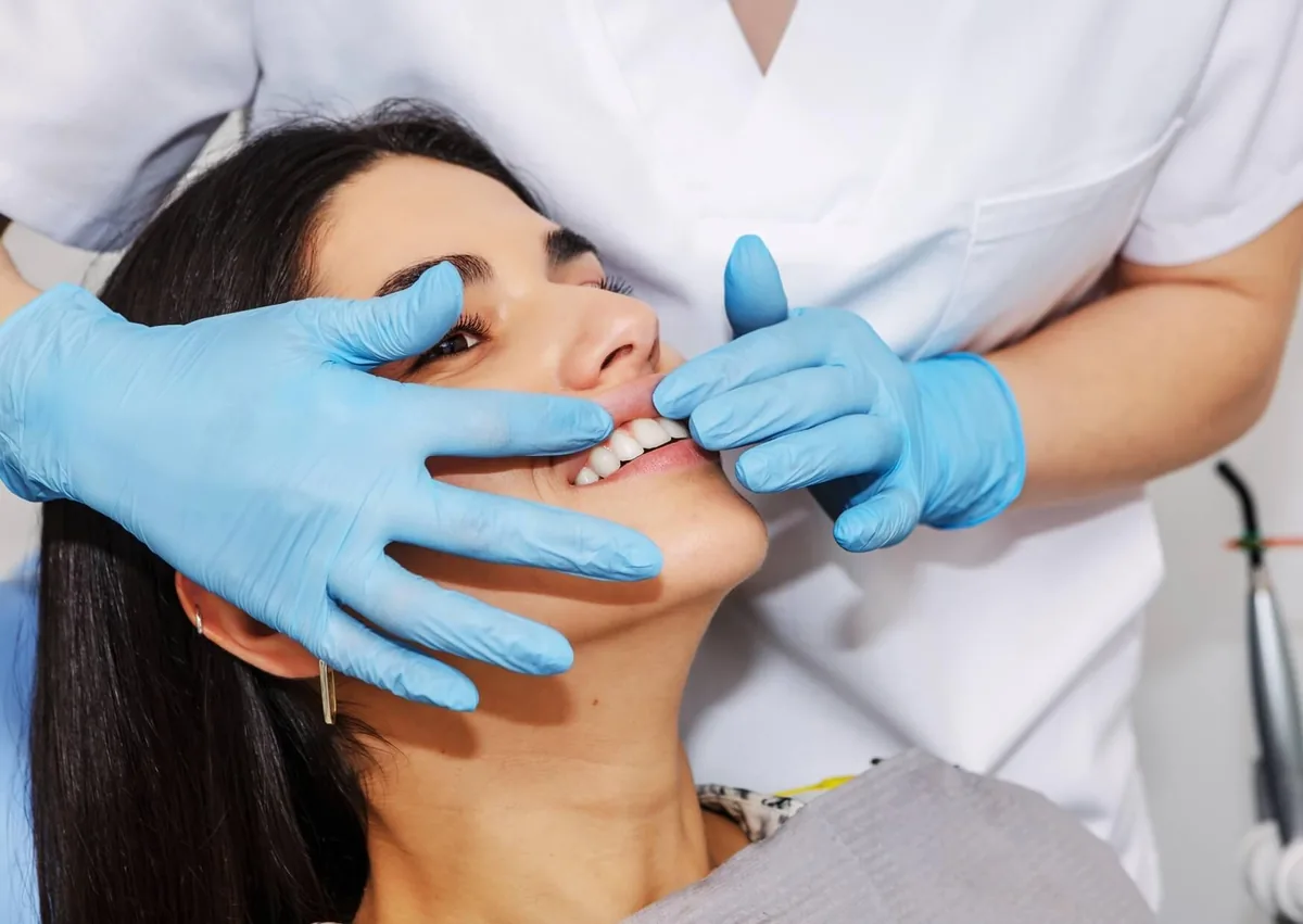 Dental professional examining a patient’s gums for signs of gingivitis and periodontitis.