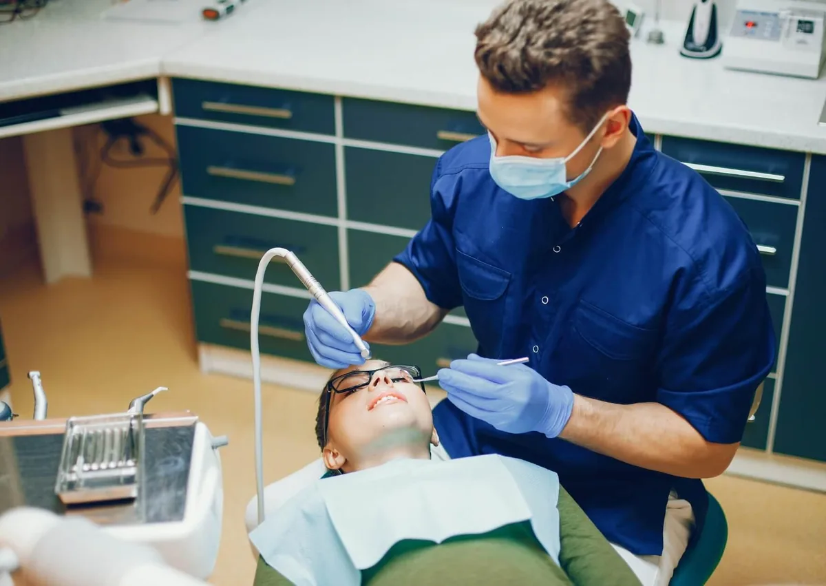 Dentist treating a relaxed patient during a procedure performed with oral conscious sedation.