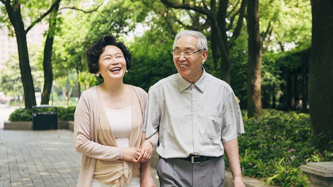 older couple smiling in park