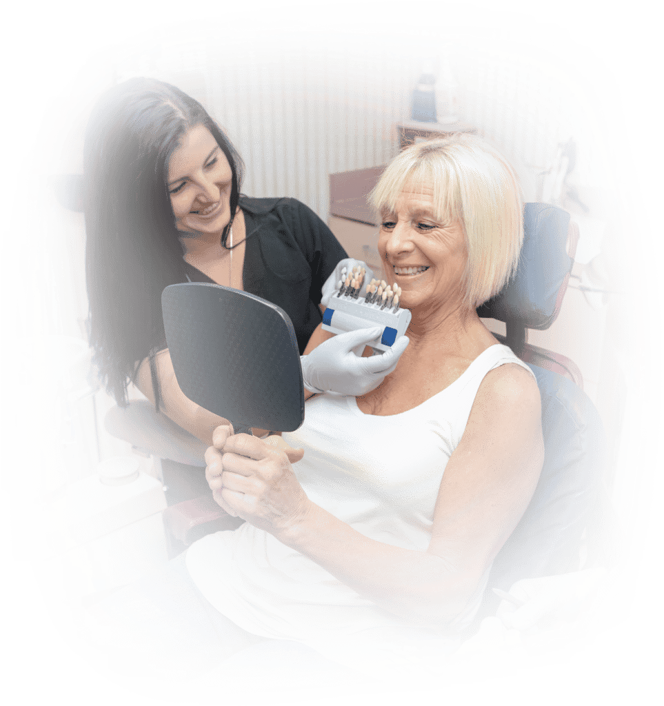 lady smiling in mirror with dentist