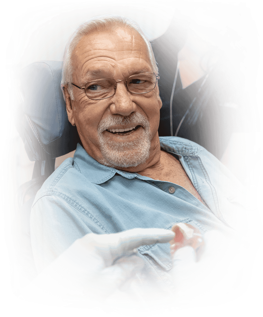 man smilin with new dentures
